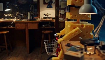MiniMax H3 first frame: Swiss-cheese character with glasses beside a red bicycle in a workshop